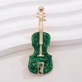 Detailed view of violin brooch with green enamel inlay and vintage gold finish details - Gold Frame Green Violin