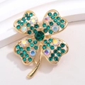 Elegant gold-tone four-leaf clover brooch with green rhinestones on textured surface - Gold with Green and AB Rhinestones (XZ182)