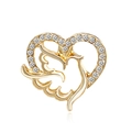 Detailed macro view of golden heart-shaped dove brooch with sparkling zircon inlays - Gold