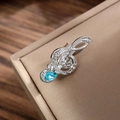 Macro shot of silver musical note brooch with sparkling rhinestones and blue crystal drop - Silver & Blue Rhinestone Style (LZ015-Teardrop-Silver Blue)