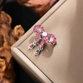 Detailed view of pink rhinestone bow brooch with crystal drop on a jewelry display box - Silver with Pink Crystal