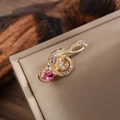 Macro shot of gold treble clef music brooch with clear rhinestones and pink teardrop stone - Gold & Pink Rhinestone Style (LZ015-Teardrop-Gold Pink)