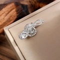 Close-up of a silver treble clef music brooch with pavé rhinestones and a pear-cut crystal - Silver White Rhinestone Teardrop Style (LZ015-Teardrop-Silver White)