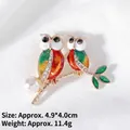 Macro detail of owl brooch with colorful enamel wings, rhinestones and a white pearl - Enamel Double Owls (XZ24096)