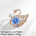 Detailed swan brooch with blue flower and crystal pave, measuring 4.1x4.8cm - Swan Shape (XZ24103)