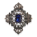 Macro detail of vintage brooch with deep blue sapphire gemstone and pearl accents - Sapphire