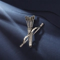 Detailed close-up of a vintage silver bow and arrow brooch with black rhinestone accents - Antique Silver (XZ24183)