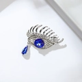 Silver evil eye brooch featuring blue crystal centerpiece and dangling teardrop gem - Evil Eye (XZ24011)