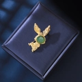 Close-up of golden bunny brooch featuring a green cat-eye stone and small sparkling rhinestones - Green Cat's Eye Rabbit Style(XZ24204)