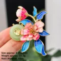 Detail of enamel peony brooch with Fu character jade inlay and gold-tone stamen - Jade Ring Peony