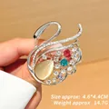Detail view of swan brooch with crystals and cat-eye stone, size 4.6x4.4cm weighing 14.7g - Silver Base (XZ24249) / Multicolor Silver Swan