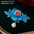 Detail of blue enamel peony brooch with red gemstone, pearls on dark green velvet - Chinese Style Sapphire Peony