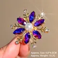 Detailed macro view of a 4x4cm snowflake brooch featuring purple zircon and a white pearl - Gold Base Purple Zircon / Purple Snowflake (XZ24383)