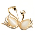Elegant gold-tone swan brooch featuring white opal gemstones and sparkling rhinestones - Gold Double Swan