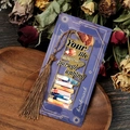 Macro detail of a golden hollow metal bookmark with long brown tassel and artistic purple card - Train Your Mind Style (T01042310)