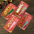Set of four floral metal hollow bookmarks with colorful tassels on a vintage wood desk - Mixed Floral Designs (BP-JSSQ4-7)