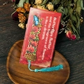 Detail of a hollow metal bookmark featuring red roses and a blue butterfly with silk tassel - Red Rose (T01042376)