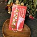 Detailed view of hollow metal tulip bookmark with pink silk tassel on a gift card - Tulip (T01042379)