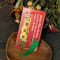 Detail of sunflower metal bookmark with green tassel and butterfly on wood tray - Sunflower (T01042377)