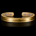 Detailed macro of 18K bicolor magnetic therapy cuff with twisted rope texture and magnets - Twisted Gold