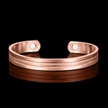 Rose gold magnetic therapy cuff bracelet with embossed diamond pattern on black background - Rose Gold
