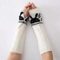 Detail of white knitted arm warmer featuring black rabbit and music note jacquard pattern - White