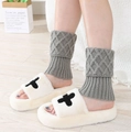 Close-up of diamond pattern knitted leg warmers and plush cross motif indoor slippers - Light Gray