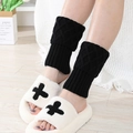 Short black diamond pattern knitted leg warmers styled with white plush cross slippers - Black