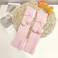 Pink knitted leg warmers for girls with cute bows and soft pom-poms for autumn - One Size / Pink