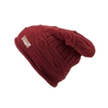 Macro detail of wine red knit beanie showing thick cable stitch and brown leather logo tag - Red