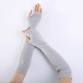 Detail of light grey ribbed knit arm warmer showing textured fabric and fingerless design - Light Gray