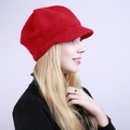 Detail view of red knitted visor beanie with warm wave pattern and thick yarn texture - One Size / Red