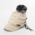 Beige winter knit visor hat featuring a grey faux fur pompom and metal eyelet lace-up detail - Beige