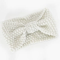 Close-up of cream knit headband with chunky textured weave and central bow knot design - Beige