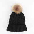 Detail of chunky cable knit texture and large faux fur pom-pom on black winter hat - One Size / Black