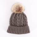 Detailed view of thick cable knit texture and large fluffy pom-pom on dark grey beanie - One Size / Dark Gray