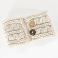 Close-up of cream cable knit ear warmer headband with lace edges and wooden buttons - Beige
