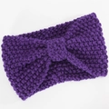 Detailed texture of thick chunky knit purple headband with a central bow design - Deep purple