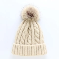 Thick cable knit beige beanie with a large brown faux fur pom pom for winter warmth - One Size / Beige