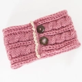 Detailed close-up of pink cable knit headband with wooden buttons and lace trim edges - Pink