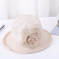 Detailed texture of beige organza sun hat with oversized mesh flower and gold trim - Beige