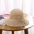 Detailed close-up of a beige crochet sun hat with breathable knit pattern and ribbon bow - One Size / Beige