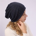 Detail of navy knit slouchy beanie with rhinestone accents on female model in cream sweater - One Size / Navy Blue