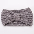 Macro detail of soft grey chenille knit texture and warm knotted bow headband design - Gray