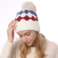 Winter beanie with cream-white knit, pom-pom, and red-blue zigzag pattern for warmth - One Size / White