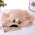 Pink wide brim straw sun hat with wavy edges and floral bow decoration for women - One Size / Pink