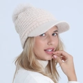 Beige knitted winter beanie hat with stylish visor and soft faux fur pom-pom detail - One Size / Beige