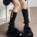 Y2K black ribbed knit leg warmers with gold buttons paired with faux fur slippers - Black with Three Buttons