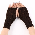 Close-up of brown knit fingerless gloves with a classic cable pattern for autumn - Coffee