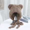 Detailed close-up of soft brown faux fur beanie with cute bear ears and long straps - One Size / Khaki